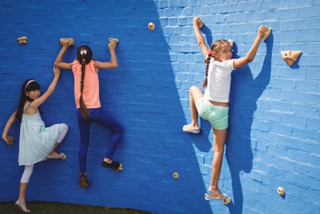 Happy kids climbing wall - Download Free Stock Photos Pikwizard.com
