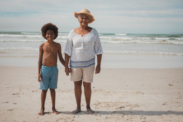 Portrait of grandmother and grandson smiling to camera on beach - Download Free Stock Photos Pikwizard.com