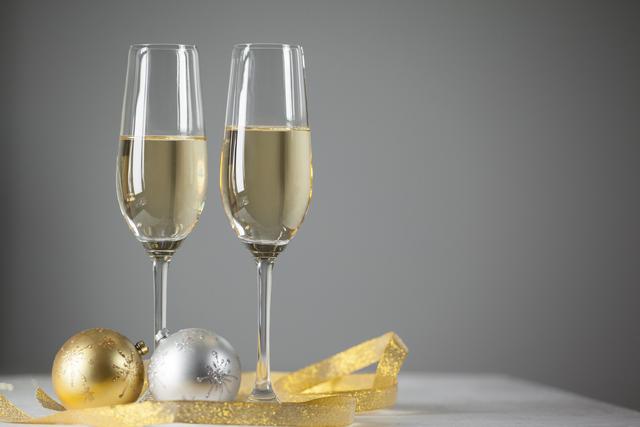 Two champagne flutes and Christmas decoration - Download Free Stock Photos Pikwizard.com