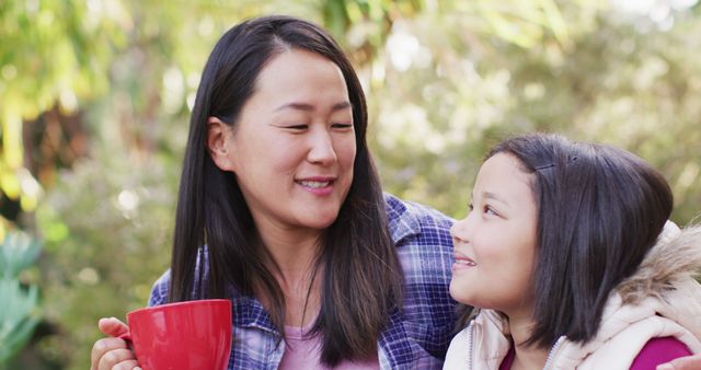 Image of happy asian mother and daughter embracing and talking in garden - Download Free Stock Photos Pikwizard.com