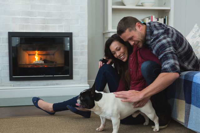 Couple relaxing with their pet dog in living room - Download Free Stock Photos Pikwizard.com