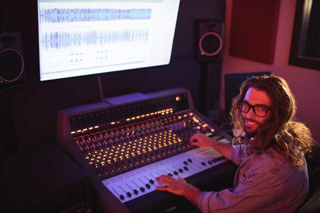 Portrait of male audio engineer using sound mixer - Download Free Stock Photos Pikwizard.com
