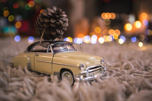 Toy car carrying christmas pine cone - Download Free Stock Photos Pikwizard.com