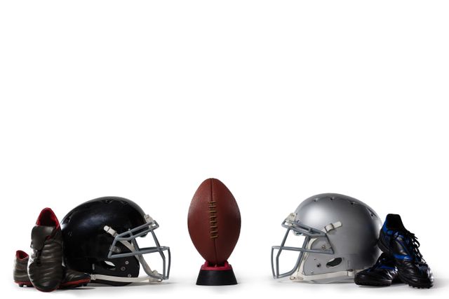 American football on tee by sports shoes and helmets - Download Free Stock Photos Pikwizard.com