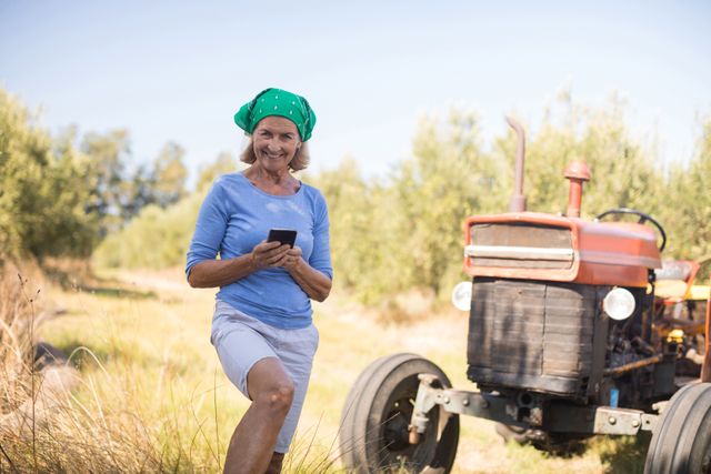 Portrait of happy woman using mobile phone in olive farm - Download Free Stock Photos Pikwizard.com