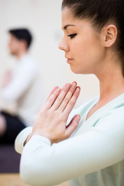 Close-up of beautiful woman sitting in lotus position - Download Free Stock Photos Pikwizard.com