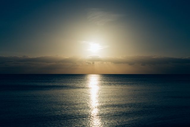 Calm Sea With Sun Setting Photo - Download Free Stock Photos Pikwizard.com