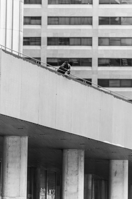 Man Looking over Railing on a Concrete Building - Download Free Stock Photos Pikwizard.com