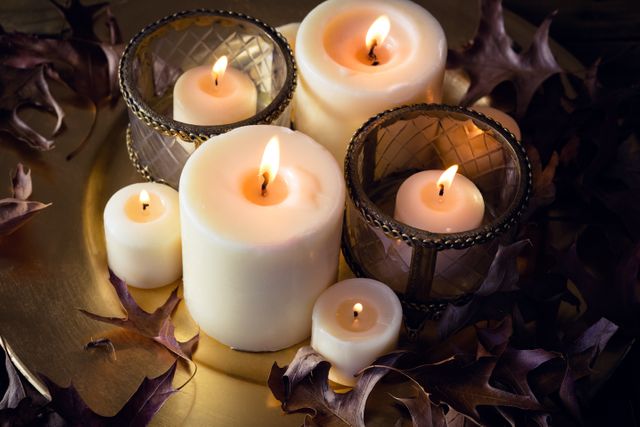 Lit candles and dry leaves on table - Download Free Stock Photos Pikwizard.com