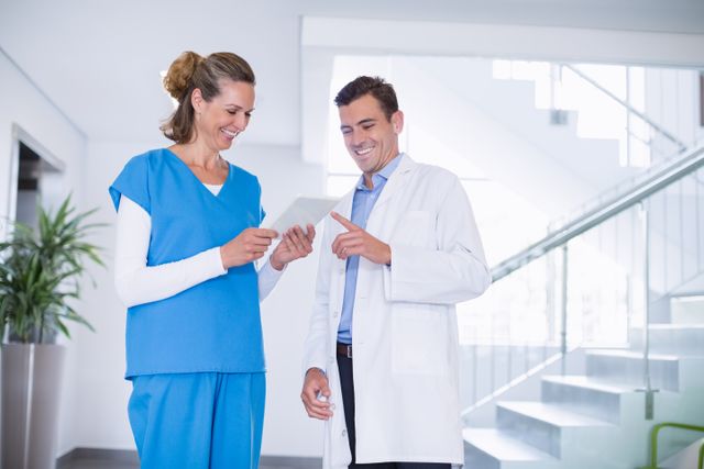Nurse and doctor discussing over digital tablet - Download Free Stock Photos Pikwizard.com