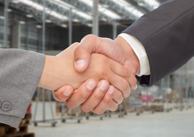 Businessman shaking hands against warehouse in background - Download Free Stock Photos Pikwizard.com