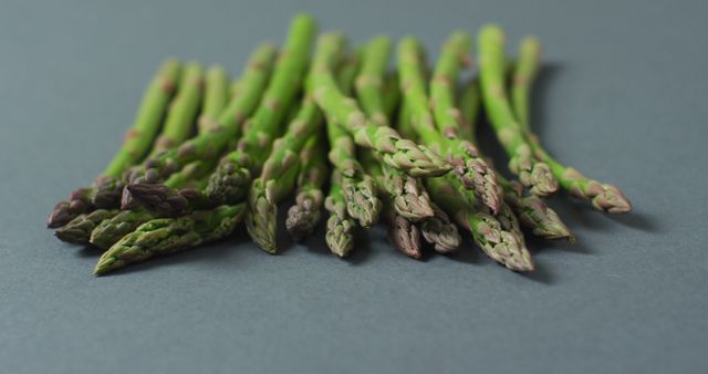Image of close up of fresh asparagus over grey background - Download Free Stock Photos Pikwizard.com