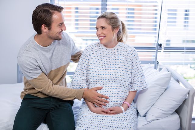 Man comforting pregnant woman in ward - Download Free Stock Photos Pikwizard.com