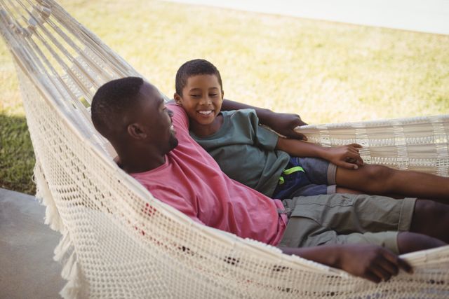 Smiling father and son relaxing on a hammock - Download Free Stock Photos Pikwizard.com