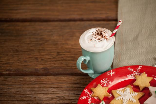 A cup of cappuccino, coffee and dessert for breakfast on a wooden table  with a laptop computer for work and accessories. Generative AI Stock Photo