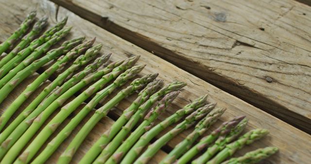 Image of fresh asparagus stalks on wooden background - Download Free Stock Photos Pikwizard.com