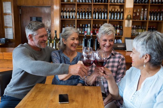 Group of smiling senior friends toasting glass of wine - Download Free Stock Photos Pikwizard.com