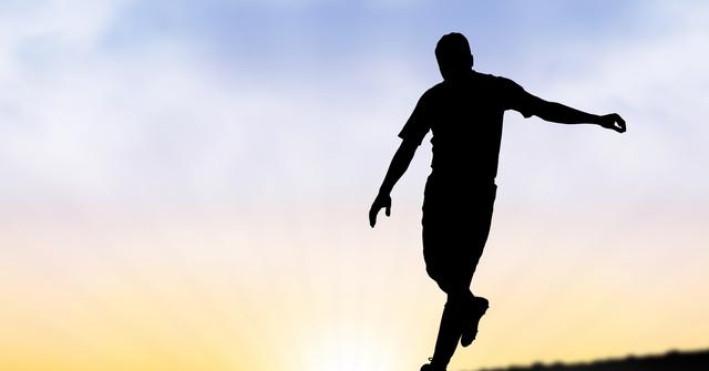 Digital composite of Silhouette man playing against sky during sunset
