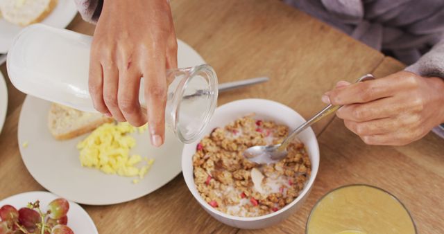 Image of hands of caucasian man preparing cereals for breakfast - Download Free Stock Photos Pikwizard.com