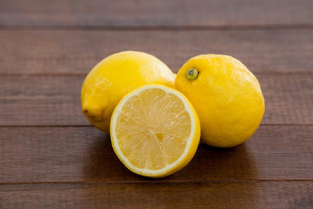 Close-up of full and half lemons on table