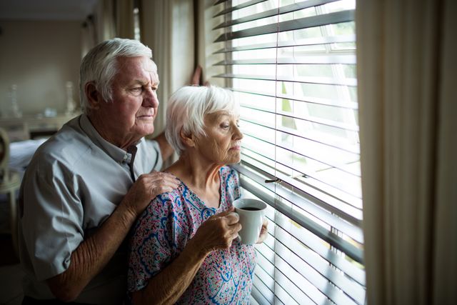 Senior couple looking out from the window - Download Free Stock Photos Pikwizard.com