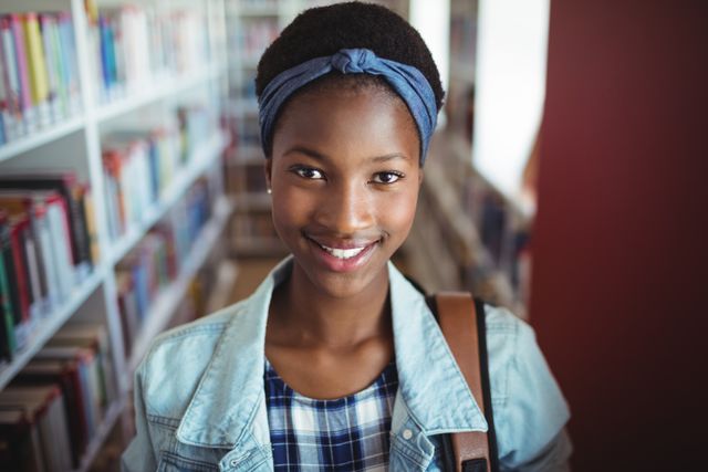 Portrait of schoolgirl smiling in library - Download Free Stock Photos Pikwizard.com
