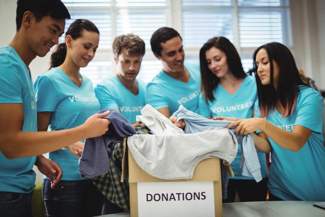 Group of volunteers checking clothes - Download Free Stock Photos Pikwizard.com