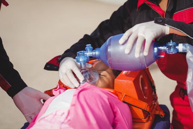 Paramedic giving oxygen to injured girl - Download Free Stock Photos Pikwizard.com