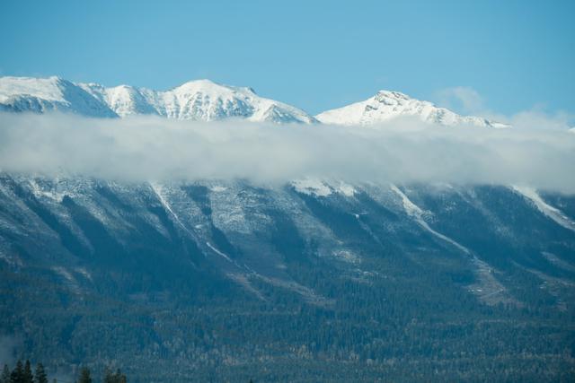 View of snowy mountain range against blue sky