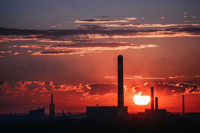 a factory at sunset - Download Free Stock Photos Pikwizard.com