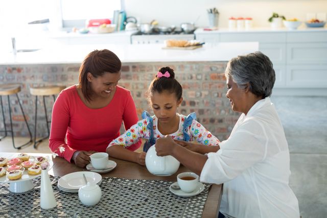 Happy multi-generation family having tea in dining table at home