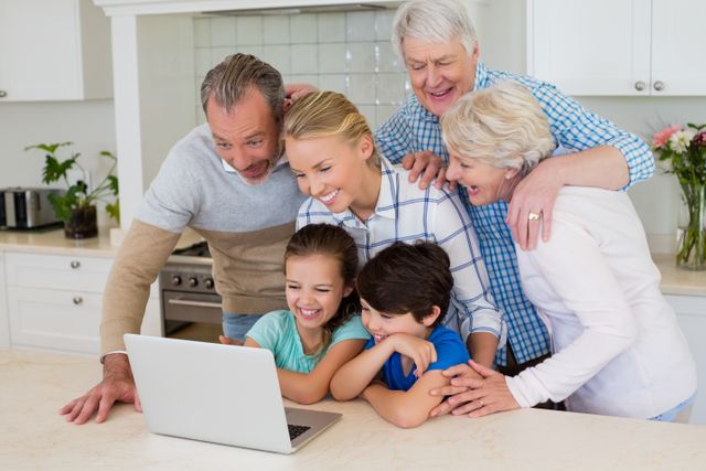 Family using laptop in kitchen - Download Free Stock Photos Pikwizard.com