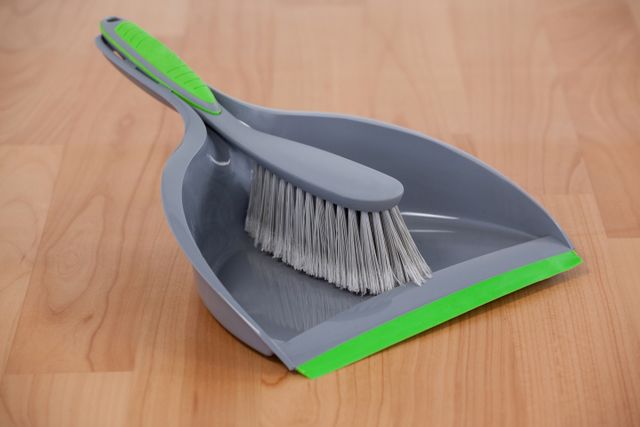 Dustpan and sweeping brush on wooden floor - Download Free Stock Photos Pikwizard.com