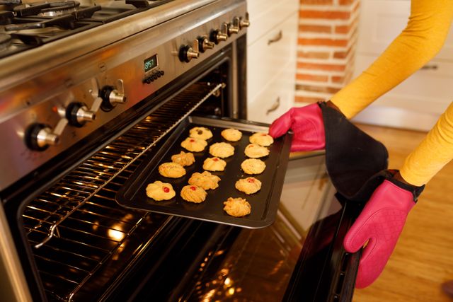 An african american woman baking cookies in the kitchen - Download Free Stock Photos Pikwizard.com