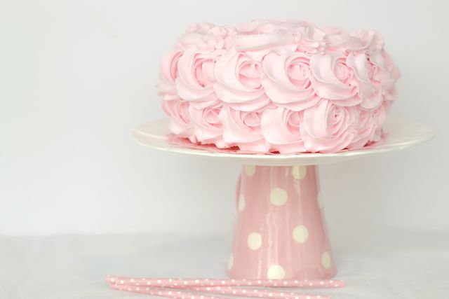 a pink cake on a cake stand - Download Free Stock Photos Pikwizard.com