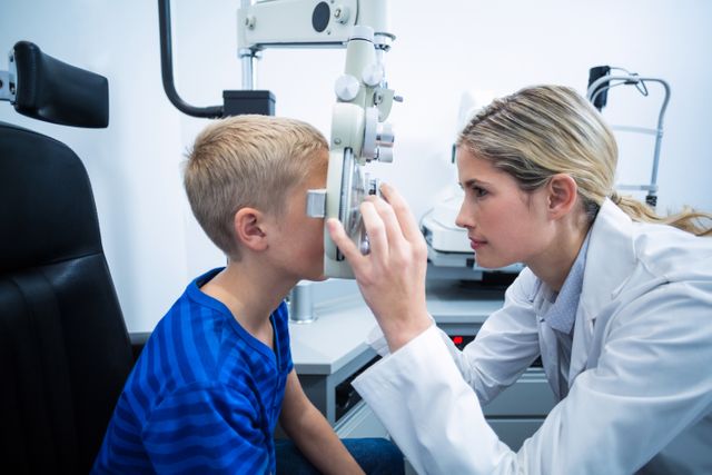 Female optometrist examining young patient on phoropter - Download Free Stock Photos Pikwizard.com