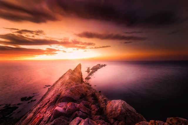 a sunset over a rocky cliff - Download Free Stock Photos Pikwizard.com