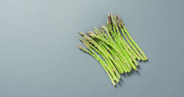 Image of fresh asparagus with copy space over grey background - Download Free Stock Photos Pikwizard.com