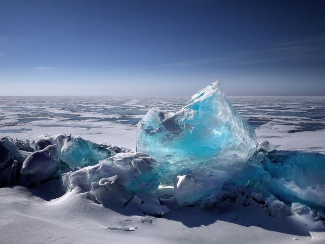 an iceberg that is covered in blue ice - Download Free Stock Photos Pikwizard.com