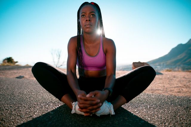 Fit african american woman stretching in countryside at sunset - Download Free Stock Photos Pikwizard.com