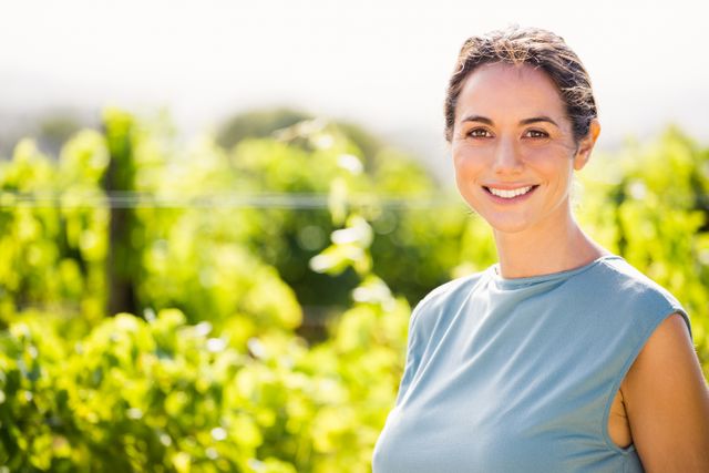 Portrait of smiling woman at vineyard - Download Free Stock Photos Pikwizard.com