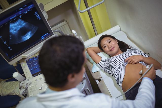 Female patient receiving a ultrasound scan on the stomach in hospital