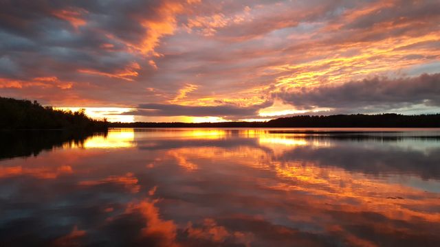 a sunset over a lake - Download Free Stock Photos Pikwizard.com