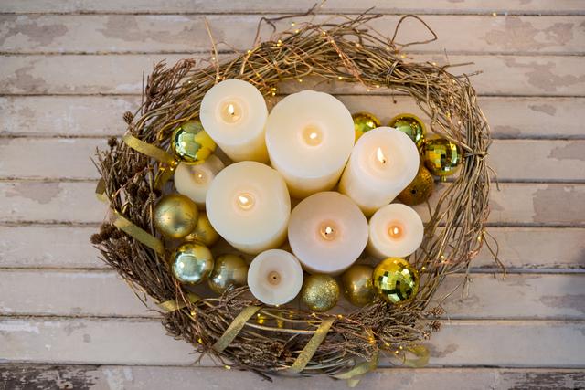 Candles and bauble ball in nest basket on wooden plank - Download Free Stock Photos Pikwizard.com