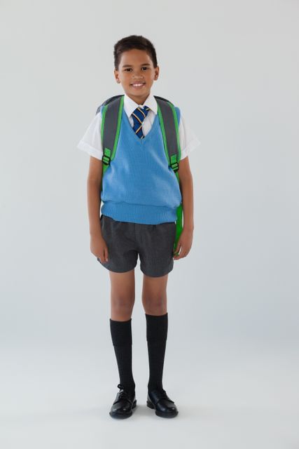 Schoolboy in school uniform with school bag on white background - Download Free Stock Photos Pikwizard.com