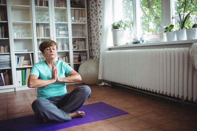 Senior woman meditating in prayer position - Download Free Stock Photos Pikwizard.com
