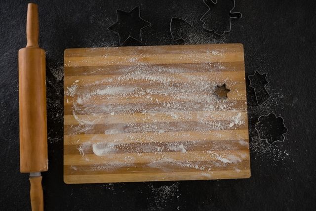 Flour on chopping board with various cookie cutters and rolling pin - Download Free Stock Photos Pikwizard.com