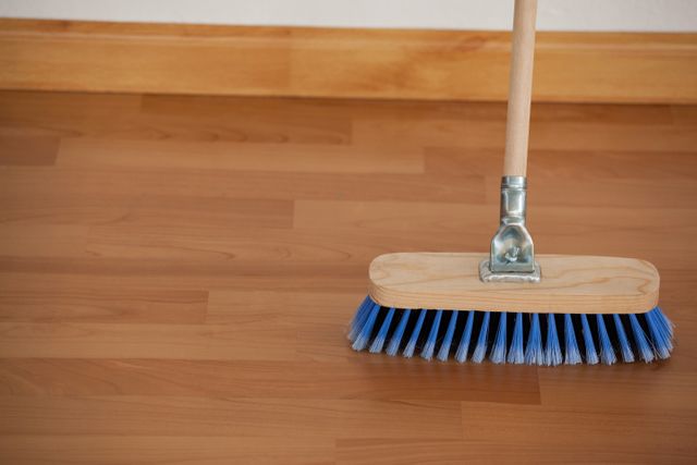Sweeping broom with wooden handle on floor - Download Free Stock Photos Pikwizard.com