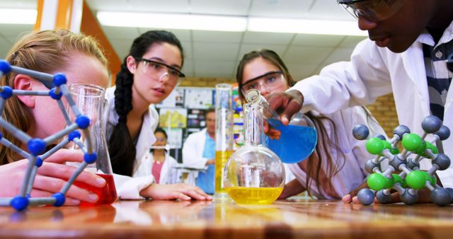 Teenage students actively participate in a hands-on chemistry experiment in a lab. - Download Free Stock Photos Pikwizard.com