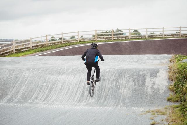 Cyclist riding BMX bike in skatepark - Download Free Stock Photos Pikwizard.com